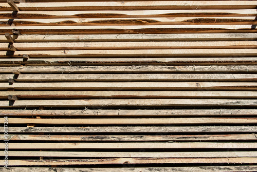 Fresh wooden boards stacked to the warehouse. Wood background