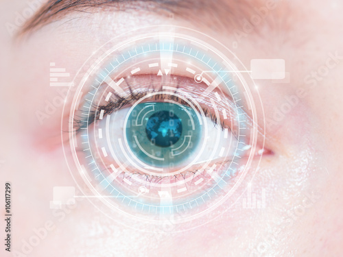 Close-up of woman's blue eye. High technology in the futuristic.