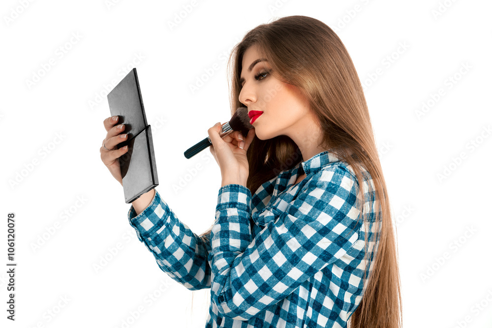 Attractive girl in casual clothes makes a make-up Attractive girl in casual clothes makes a make-up