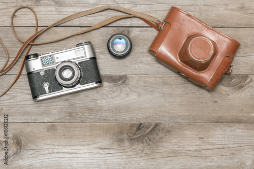 retro camera and cover lay on the aged boards photo