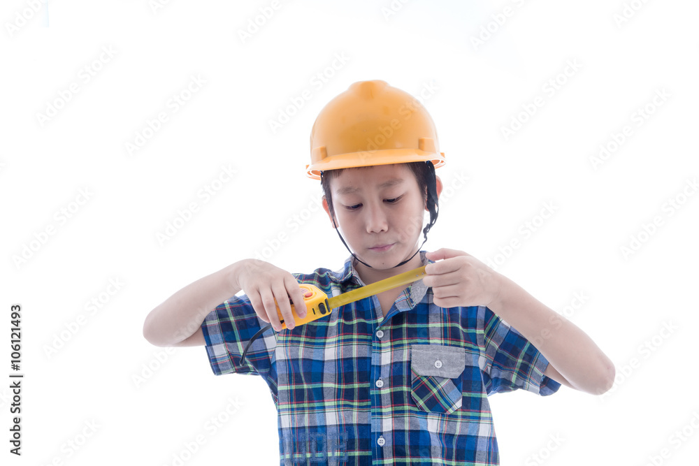 Asian boy dressed like worker holding measuring tape on white. Asian boy dressed like worker holding measuring tape on white.