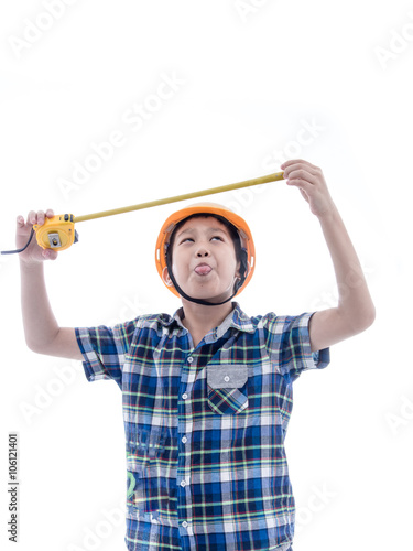 Asian boy dressed like worker holding measuring tape on white.