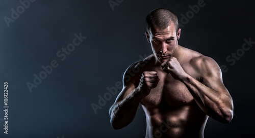 Photography muscular powerful man in full guard ready for fight with copy space