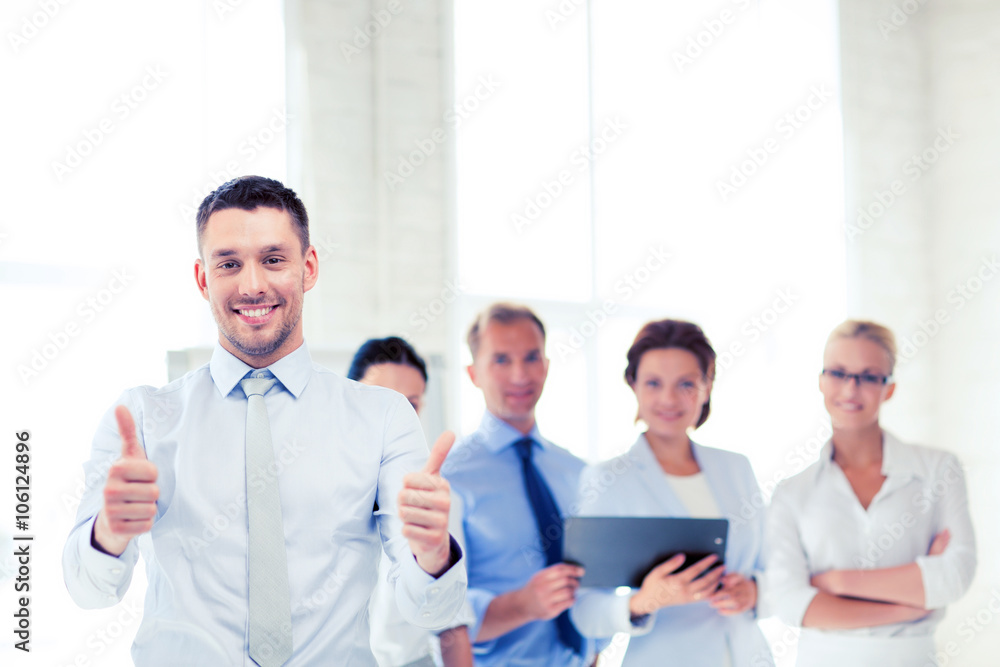 businessman in office showign thumbs up businessman in office showign thumbs up