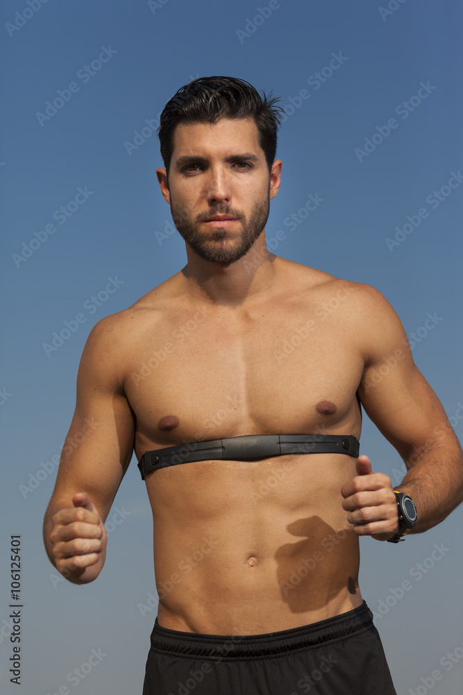 Fototapeta premium running photo of young handsome man with heartbeat meter.selecti