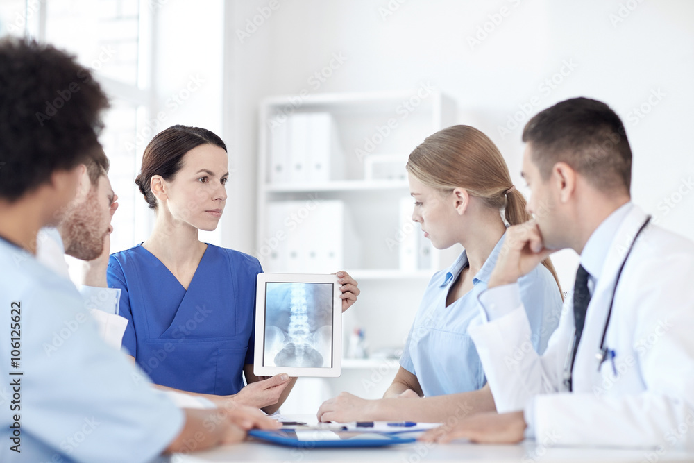group of doctors with x-ray on tablet pc at clinic group of doctors with x-ray on tablet pc at clinic