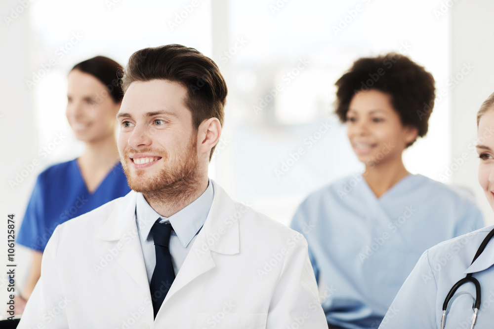 happy doctor over group of medics at hospital happy doctor over group of medics at hospital