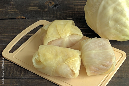  Stuffed cabbage.  Stuffed cabbage with rice and meat on a cutting board on a wooden background.
 