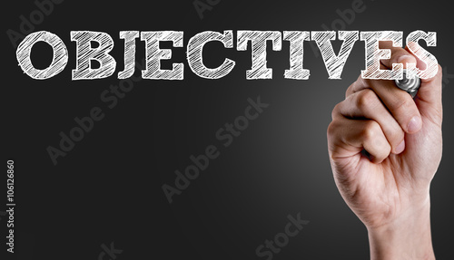 Hand writing the text: Objectives photo