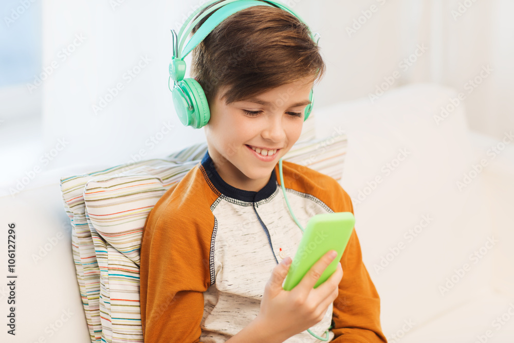 happy boy with smartphone and headphones at home happy boy with smartphone and headphones at home