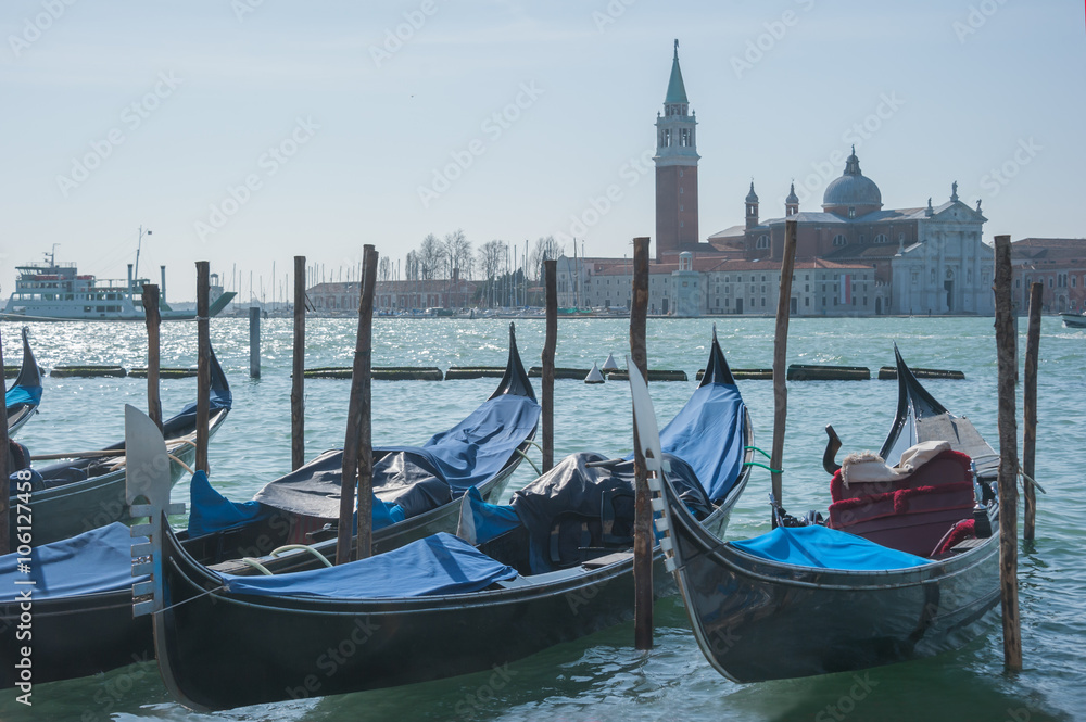 Venice with gondolas on Grand Canal against San Giorgio Maggiore church background.