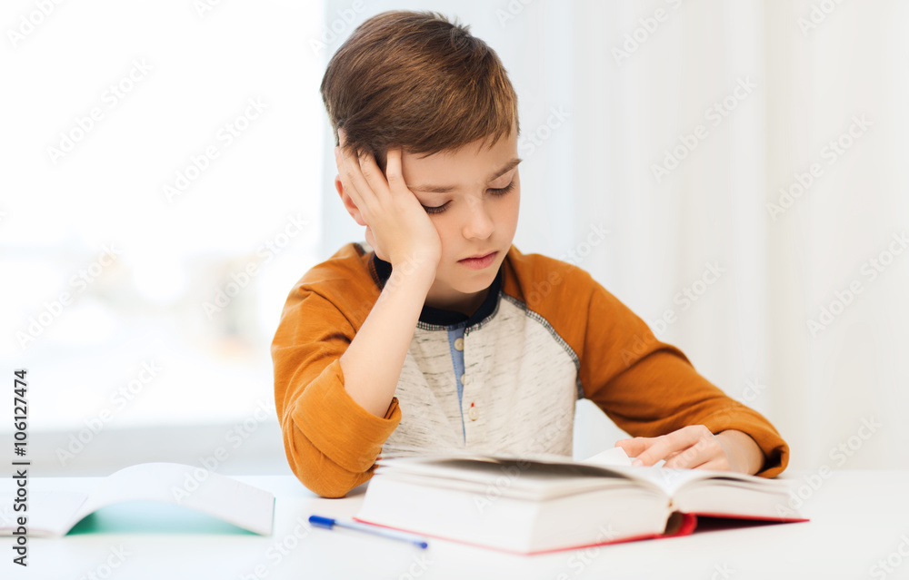 student boy reading book or textbook at home student boy reading book or textbook at home