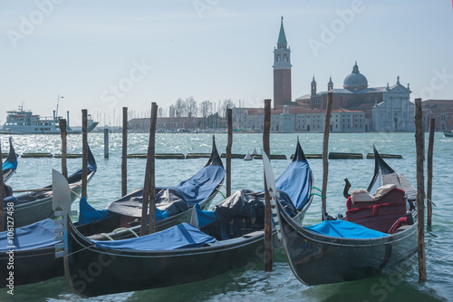 Venice with gondolas on Grand Canal against San Giorgio Maggiore church background.