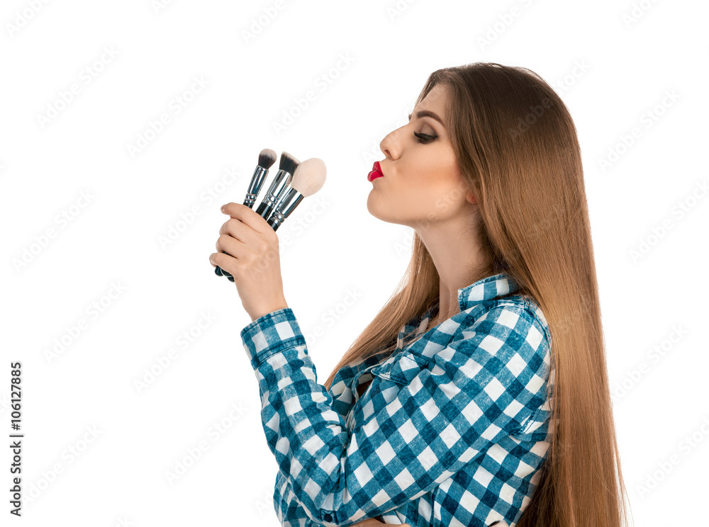 Profile portrait of beautiful make up artist with brushes on whi Profile portrait of beautiful make up artist with brushes on whi