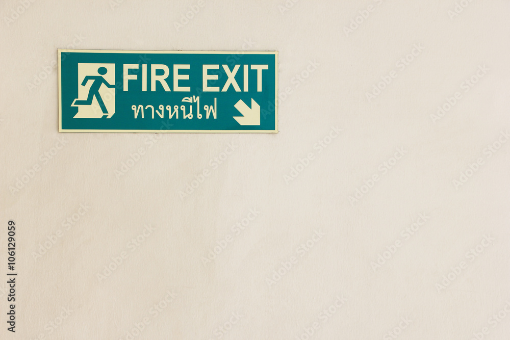 Fire Exit plate glow in the dark on old wall