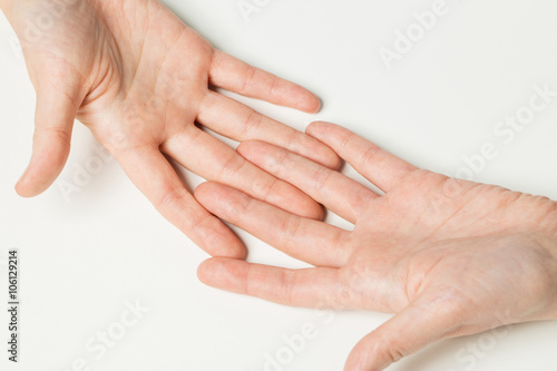 close up of two hands connecting fingers together