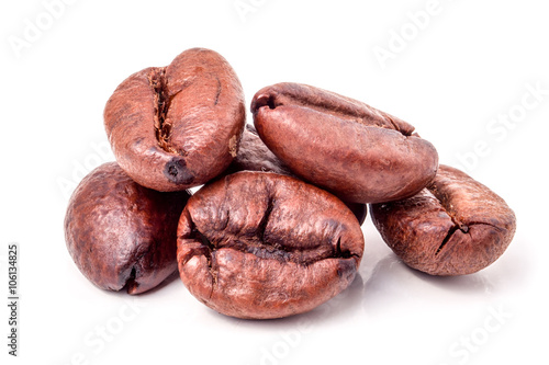 Several coffee grains on white background