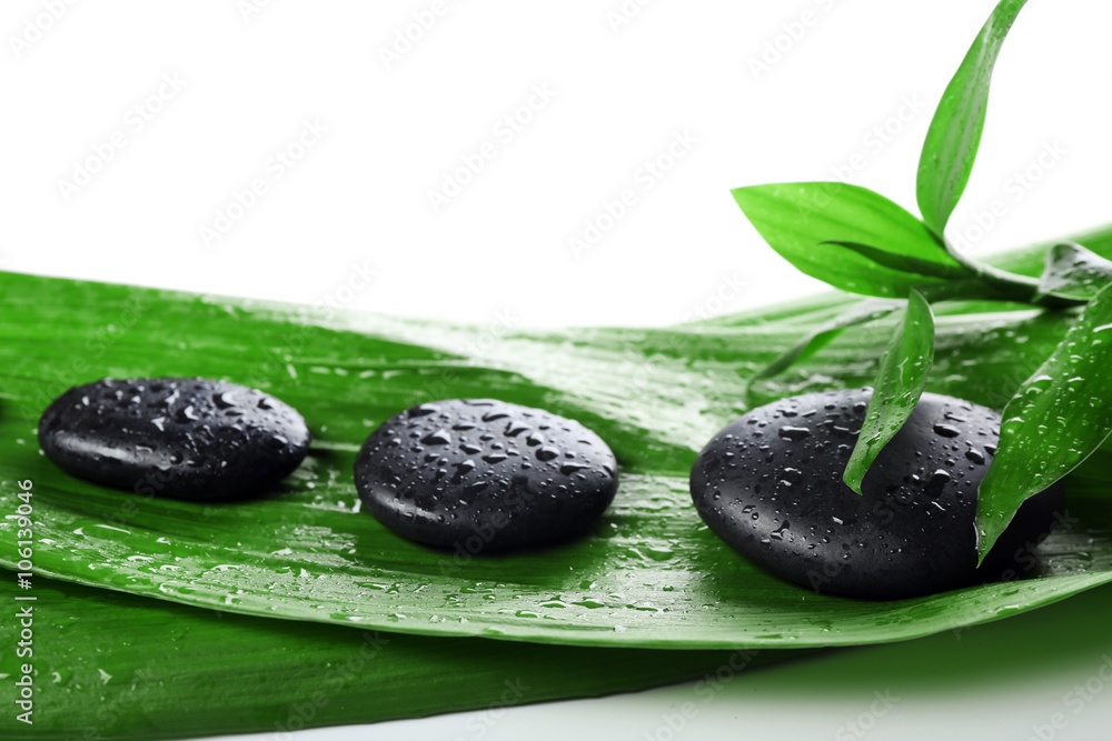 Hot spa stones with bamboo, isolated on white Hot spa stones with bamboo, isolated on white