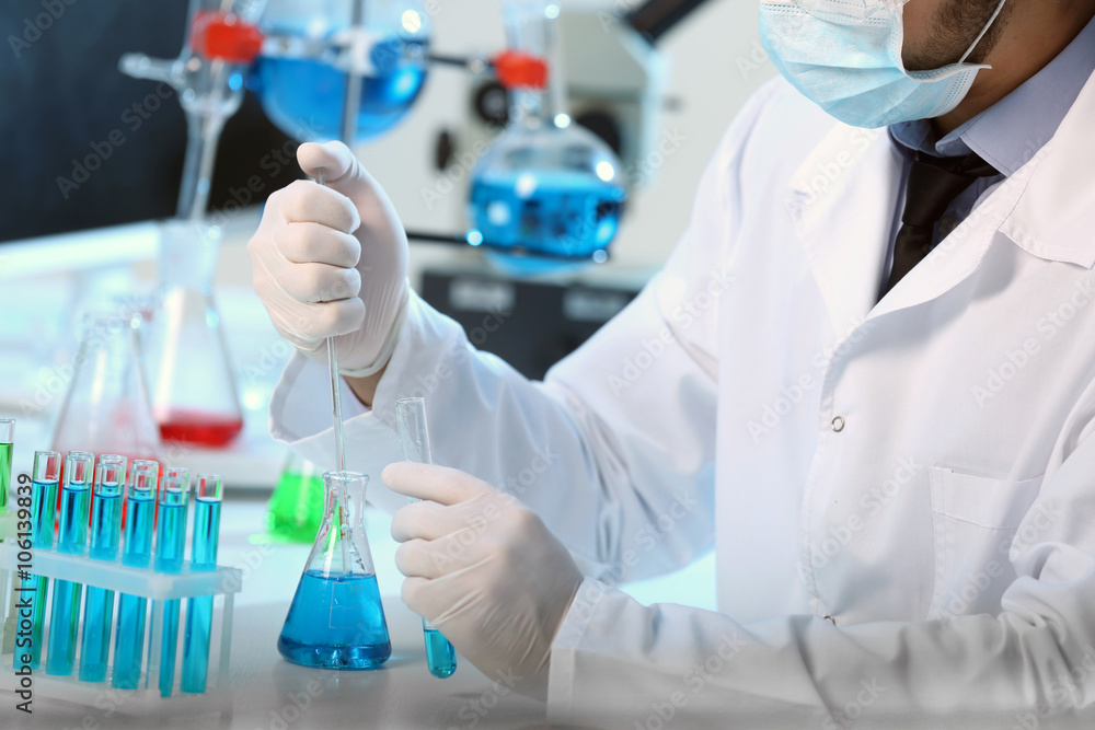 Fototapeta premium Serious clinician studying chemical element in laboratory
