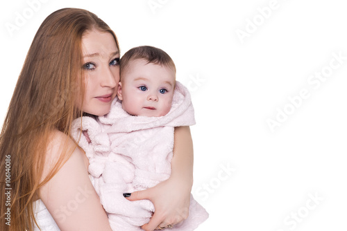 loving mother with her cute baby isolated on white. mom holding child in pink bathrobe hood with blue eyes, after shower. happy family concept