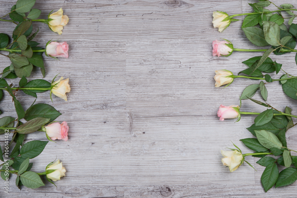 Pink and yellow roses over wooden table Pink and yellow roses over wooden table