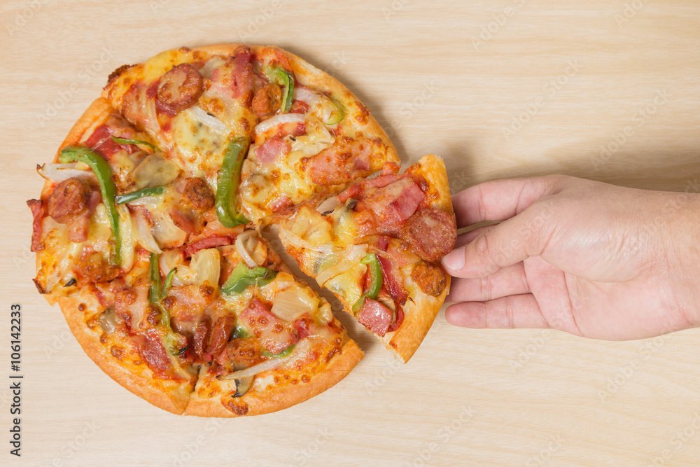 hand holding tasty flavorful pizza