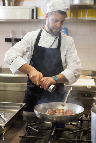 chef cooking pork tenderloin in a pan