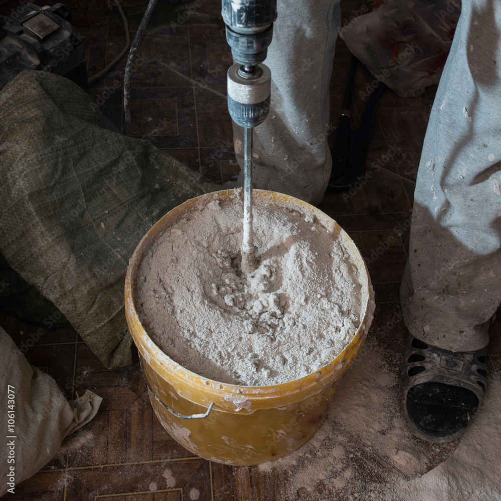 Fototapeta premium Stirring mortar using drills