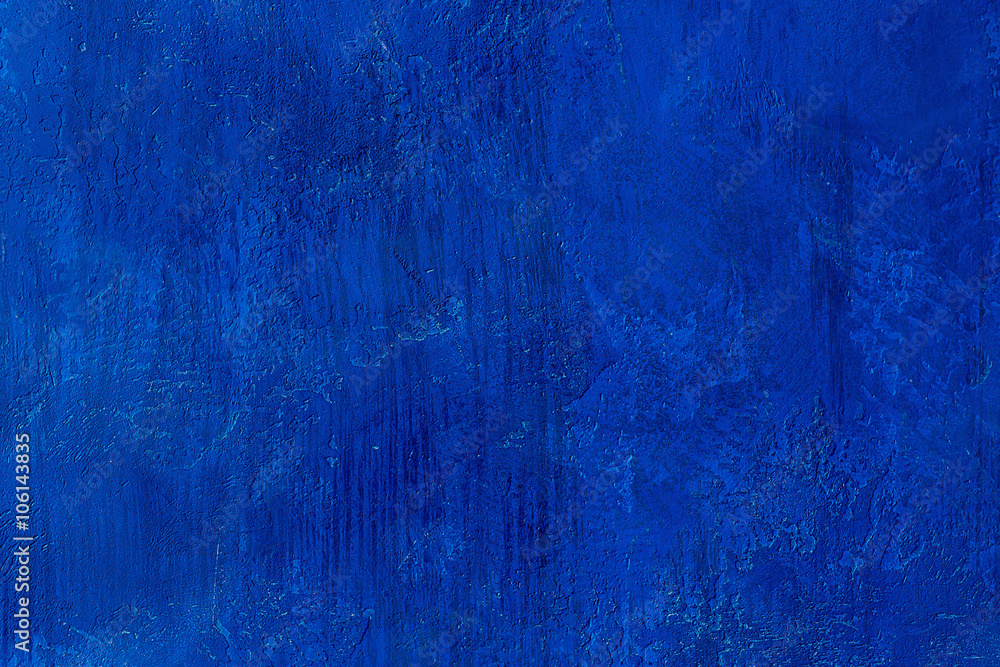 Old scratched and chapped painted royal blue wall. Abstract textured colored background, empty template