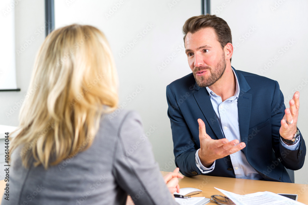 Young attractive employer doing a job interview to a woman - obrazy, fototapety, plakaty 