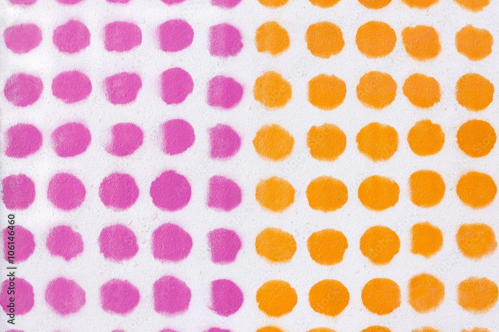 Orange and pink dot pattern over a white background.