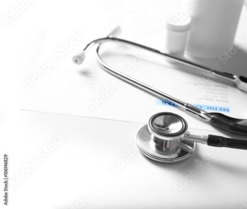 Stethoscope and medical equipment on a light background