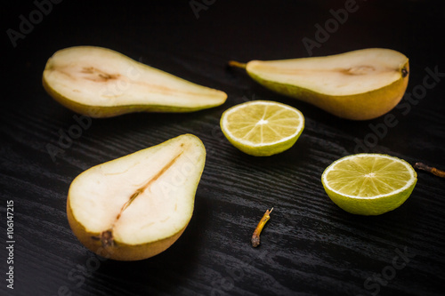 Conference Pear and lime on a black background