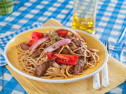 Beef, onion, and noodle stir fry, Lomo Saltado, a typical Peruvian dish