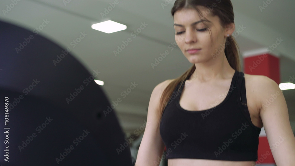 Beautiful girl on a treadmill. 4k