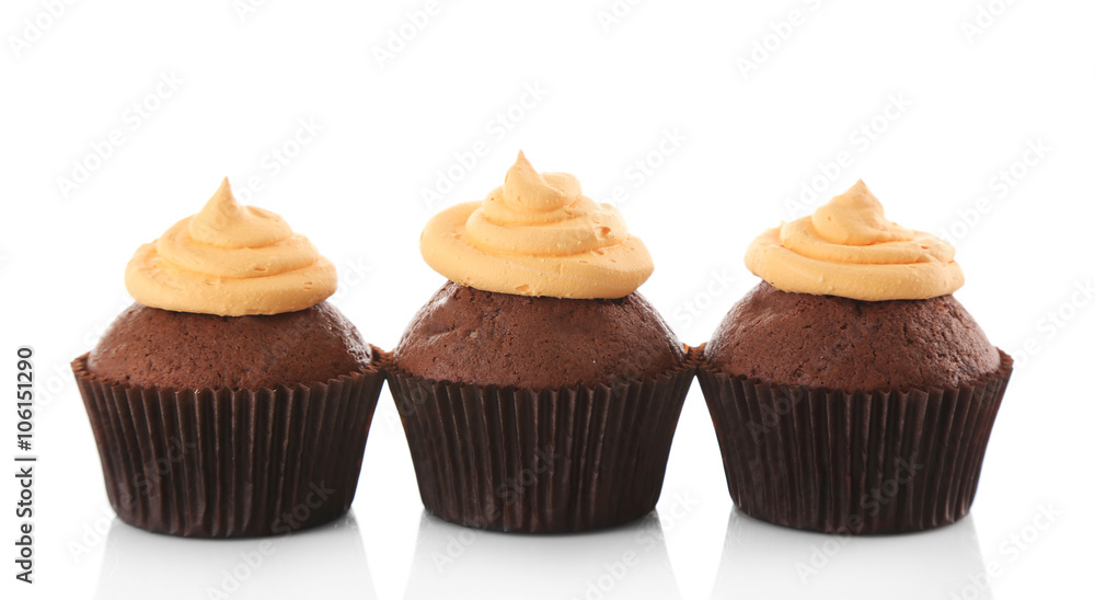 Three tasty cupcakes with cream, isolated on white