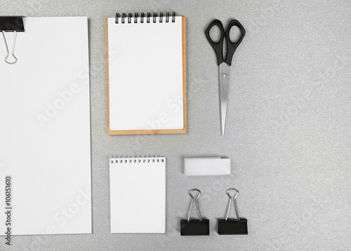 Office set with white sheets of paper, notebooks and stationery on grey background © Africa Studio