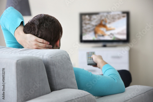 Young handsome man watching...