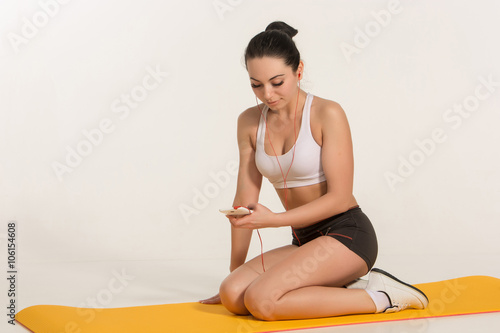 Brunette with fit body on yoga mat