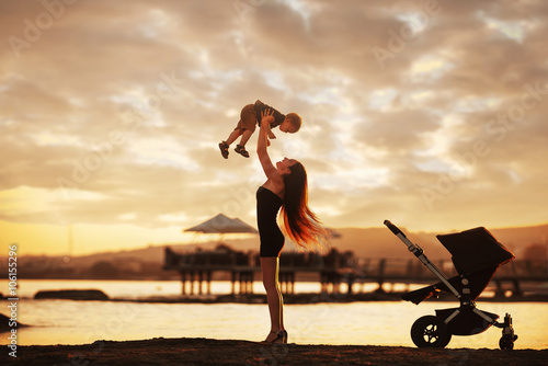 Mother and baby on the beach after sunset