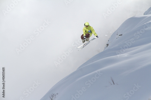 Flying skier on mountains. Extreme sport.