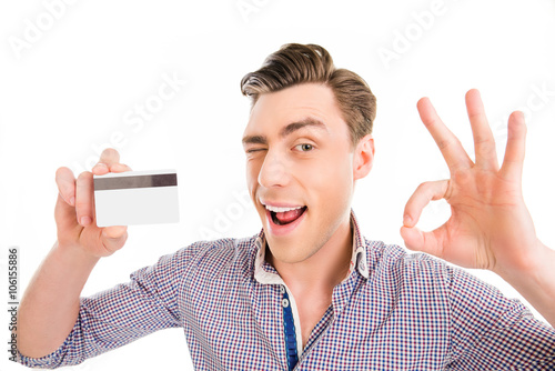 Portrait of happy man holding bank card and gesturing 