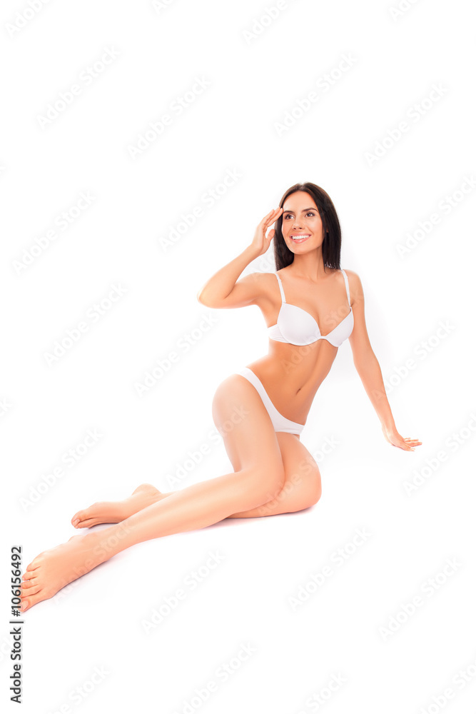 Cheerful slim woman sitting in lingerie on white background Cheerful slim woman sitting in lingerie on white background