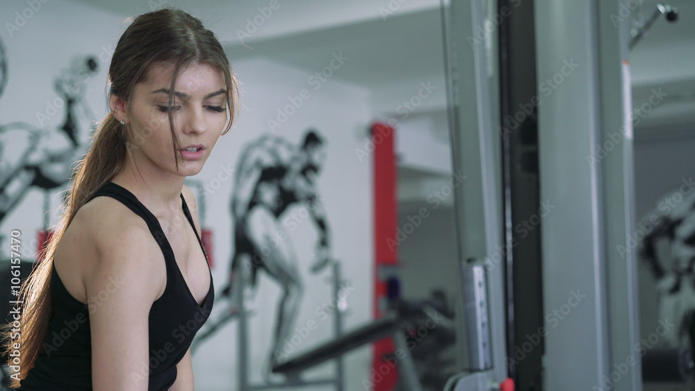 Beautiful brunette performs an exercise with dumbbells. 4k Beautiful brunette performs an exercise with dumbbells. 4k
