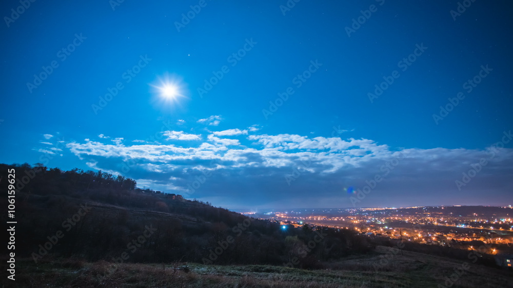 The view from the mountain on a background of cloud flow and the evening city The view from the mountain on a background of cloud flow and the evening city