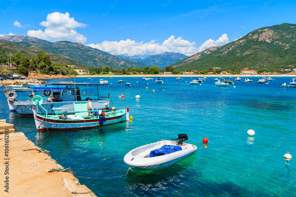 Typical fishing boats in small port on coast of southern Corsica island near Cargese town