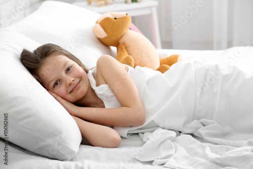 Little girl awake in bed