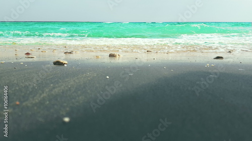 Azure surf on a sand tropical beach photo