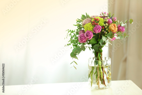 Bouquet of roses in jar on the table