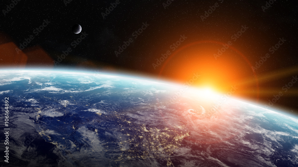 Obraz premium Wschód słońca nad planetą Ziemia w przestrzeni
